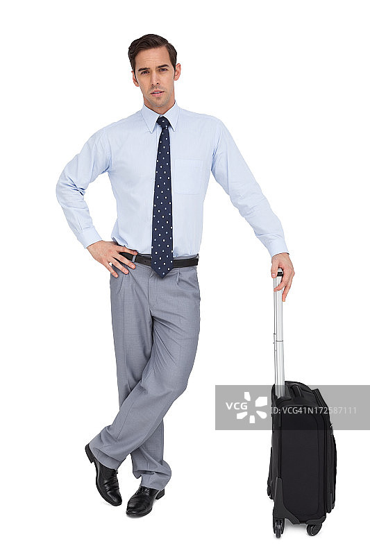 英俊的商人站在他的手提箱图片素材