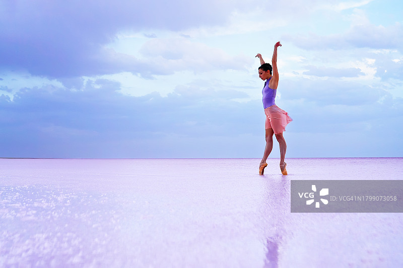 清晨，年轻的芭蕾舞女演员在湖面上翩翩起舞。图片素材