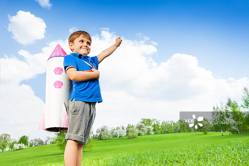 男孩穿着纸火箭玩具，手举着图片素材