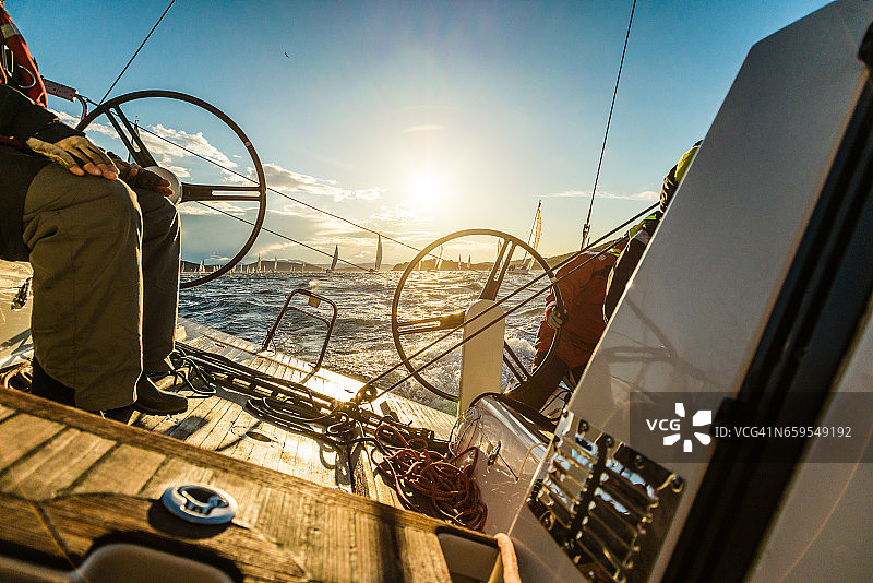 秋高气爽的早晨，帆船上的水手们正在进行帆船赛图片素材