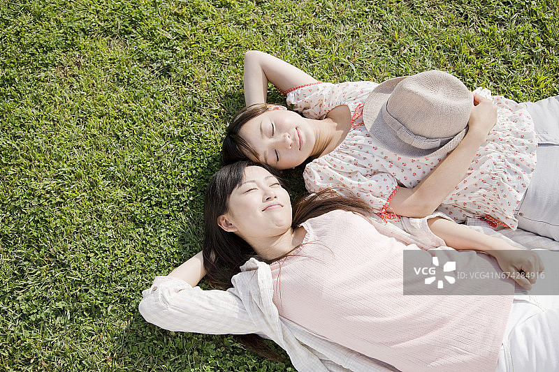 两个女人躺在草地上图片素材
