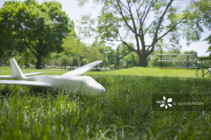 玩具飞机躺在草地上图片素材