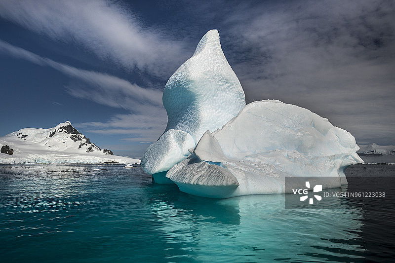 库弗维尔岛附近杰拉什海峡的冰山，背景是一艘探险船图片素材