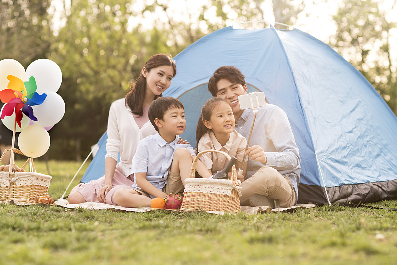 年轻家庭在户外野餐自拍图片下载