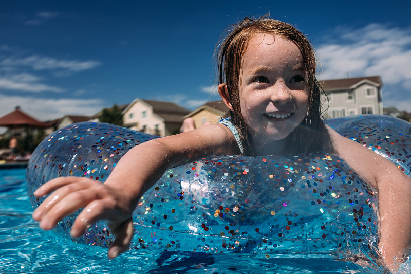 小女孩在一个圆形的浮池游泳的特写图片素材