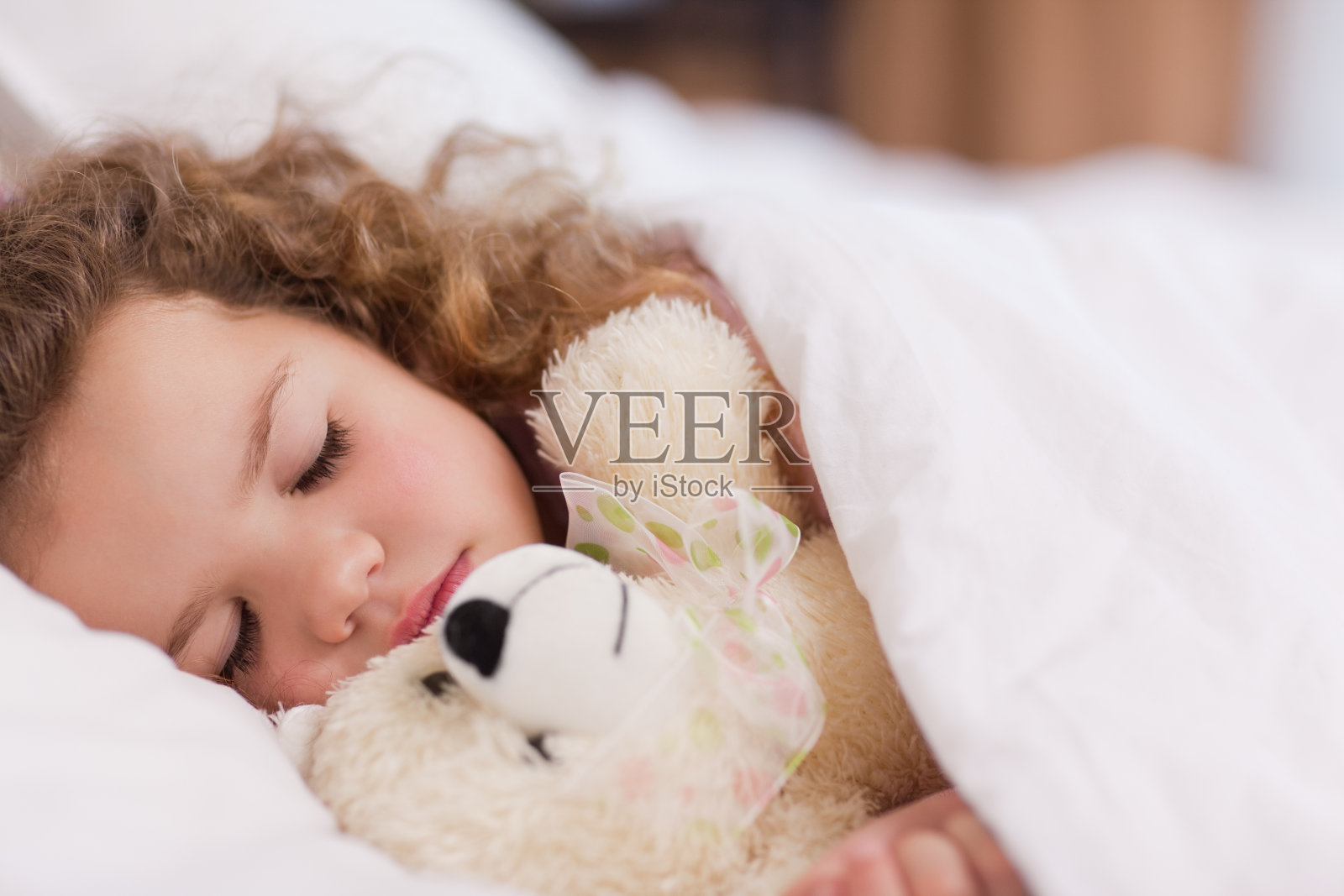 和她的泰迪熊睡觉的女孩照片摄影图片