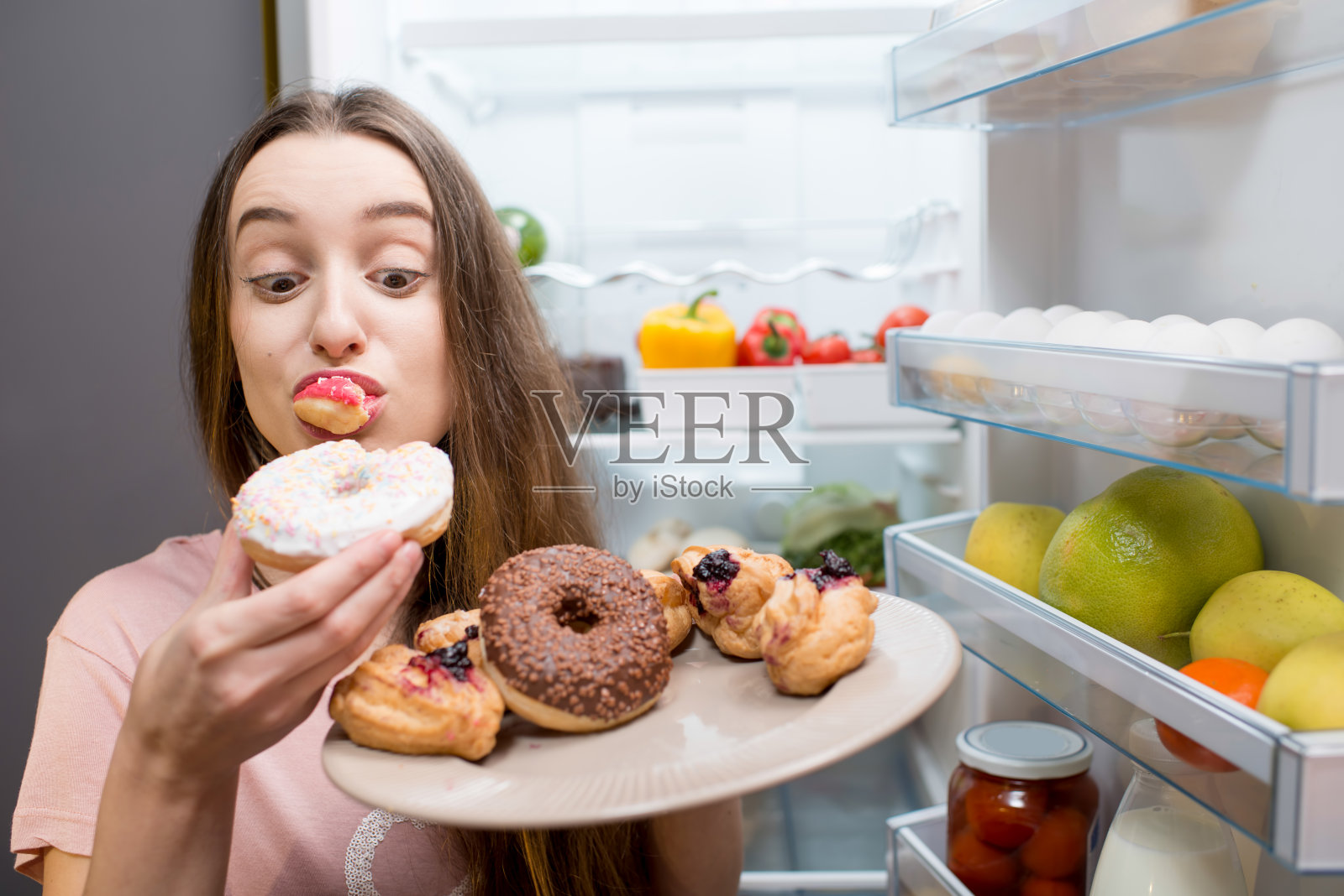冰箱附近有甜食的女人照片摄影图片