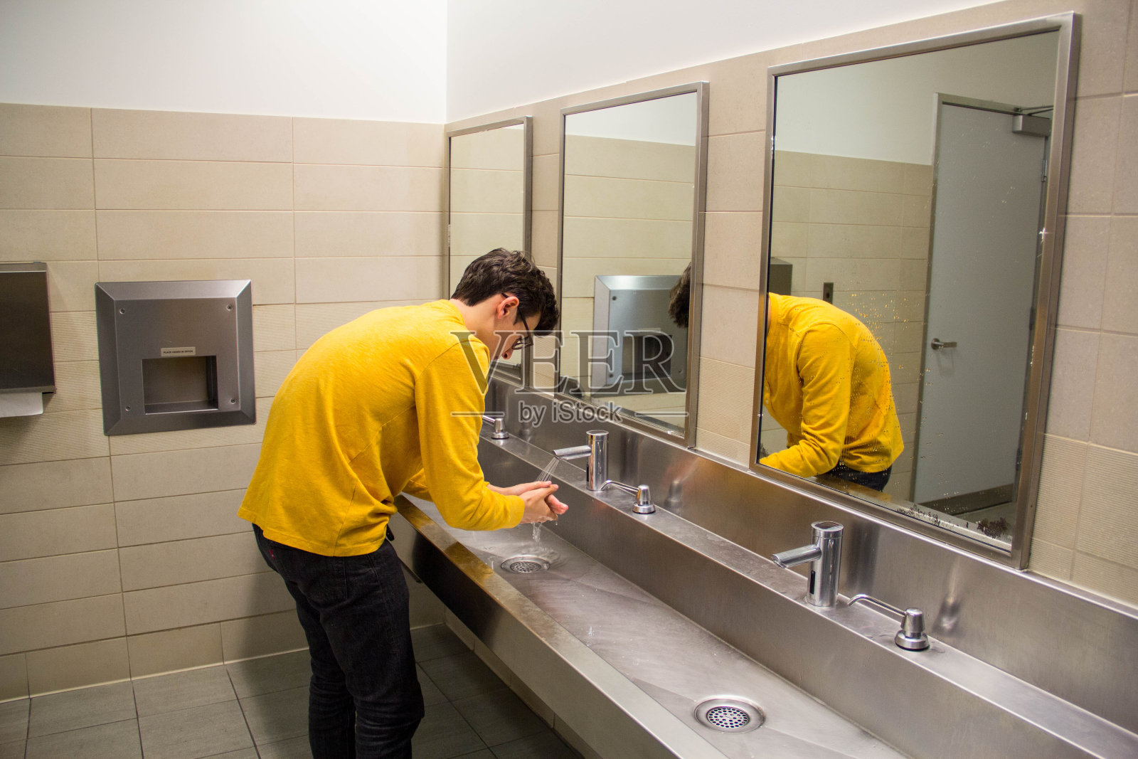 青少年在公共厕所洗手照片摄影图片