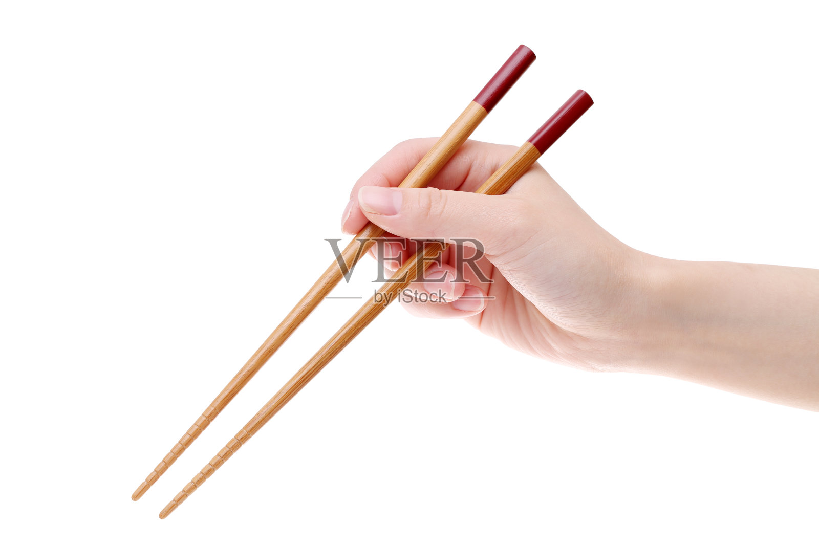 手握木筷子照片摄影图片