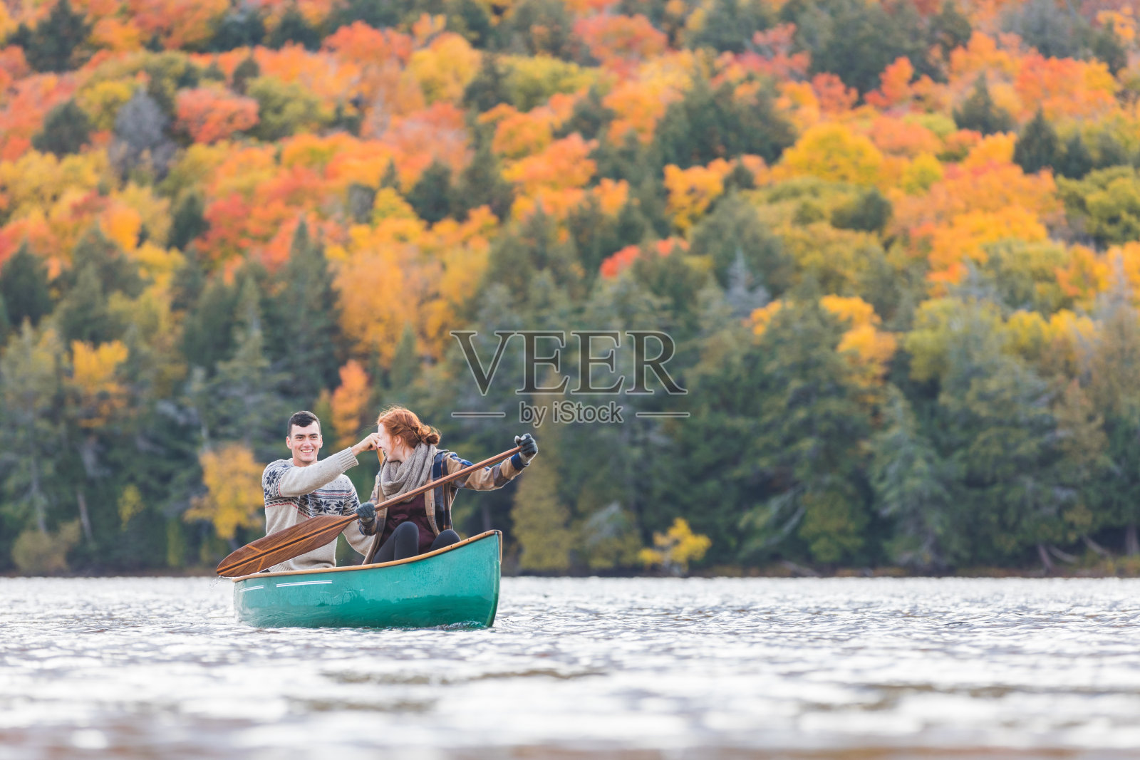 一对快乐的夫妇在加拿大的湖中划独木舟照片摄影图片