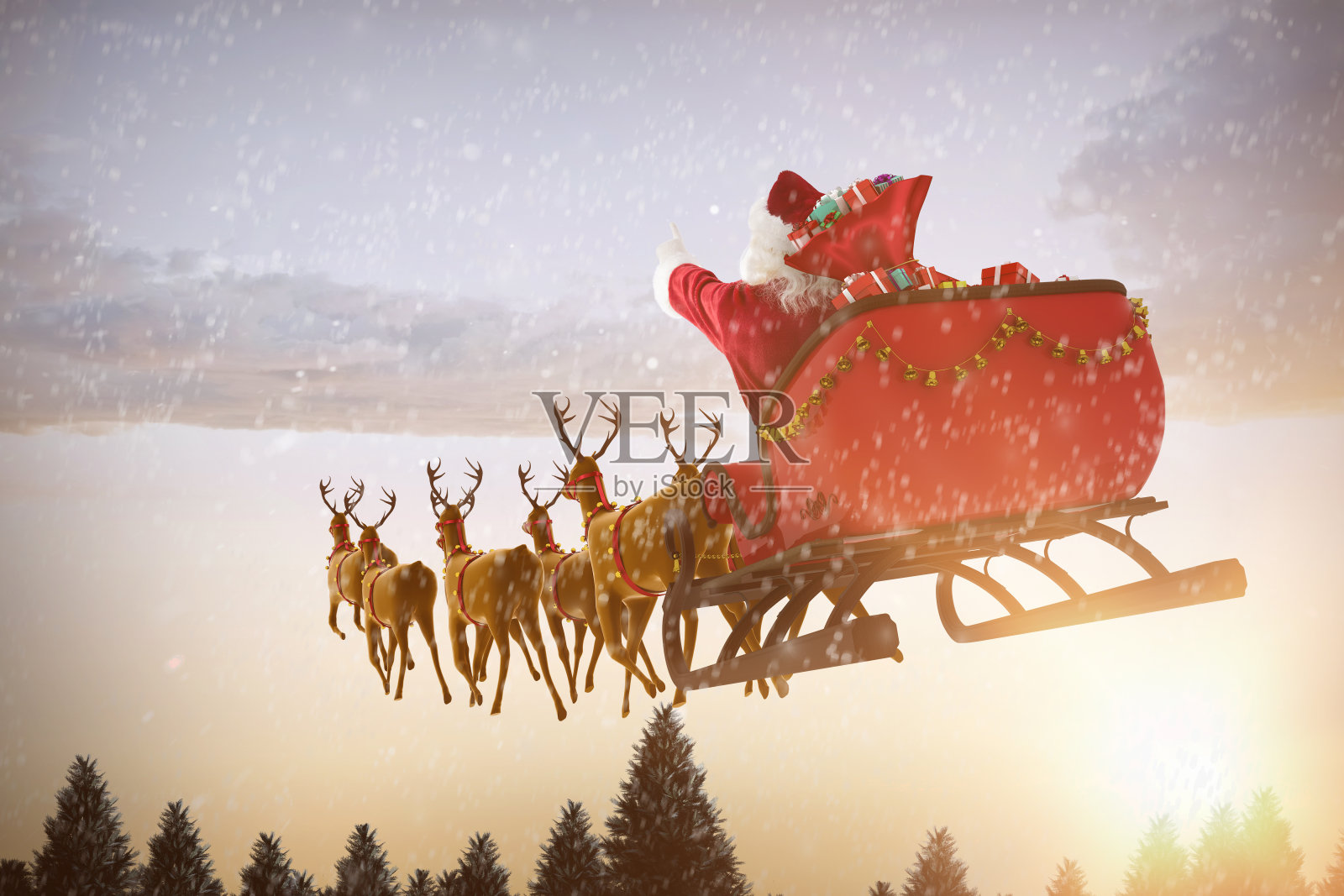 圣诞老人骑着雪橇迎着雪花飘落照片摄影图片