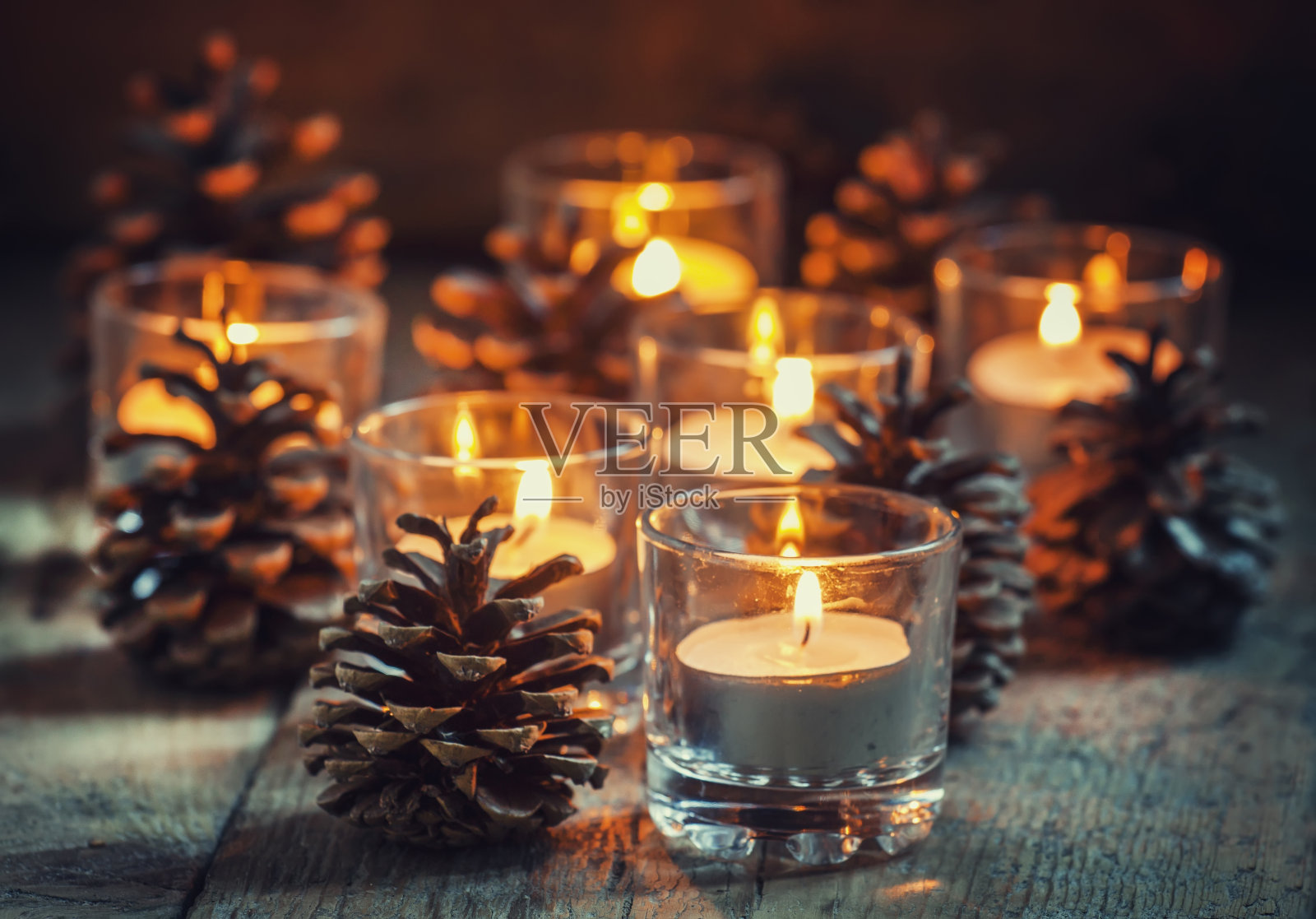 圣诞贺卡与发光的小蜡烛和冷杉锥照片摄影图片