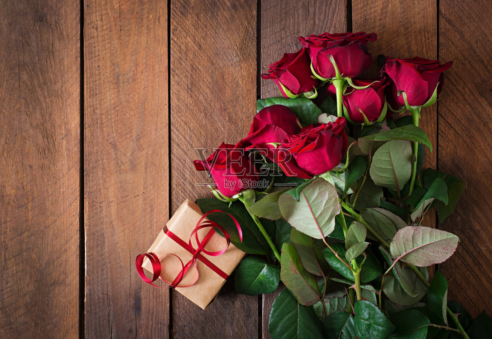 深色木质背景上的一束红玫瑰照片摄影图片