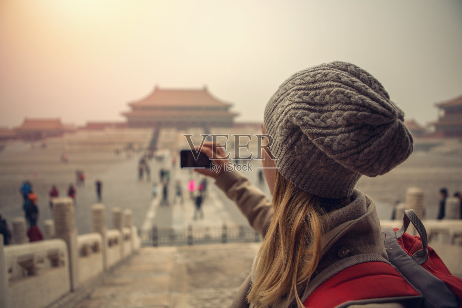 一名正在旅行的年轻女子用智能手机拍下了故宫的照片照片摄影图片