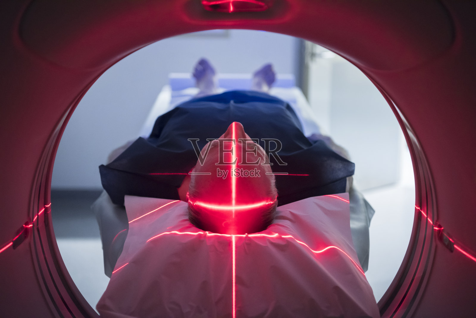 男性病人在医疗扫描器红灯照片摄影图片