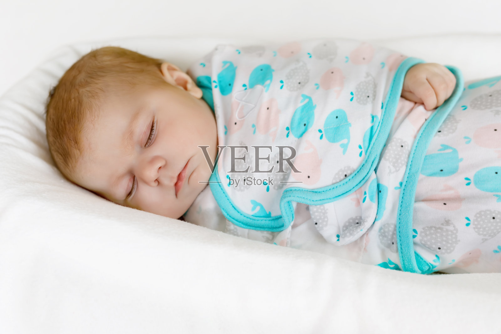 可爱的新生小女孩裹着毯子睡觉照片摄影图片