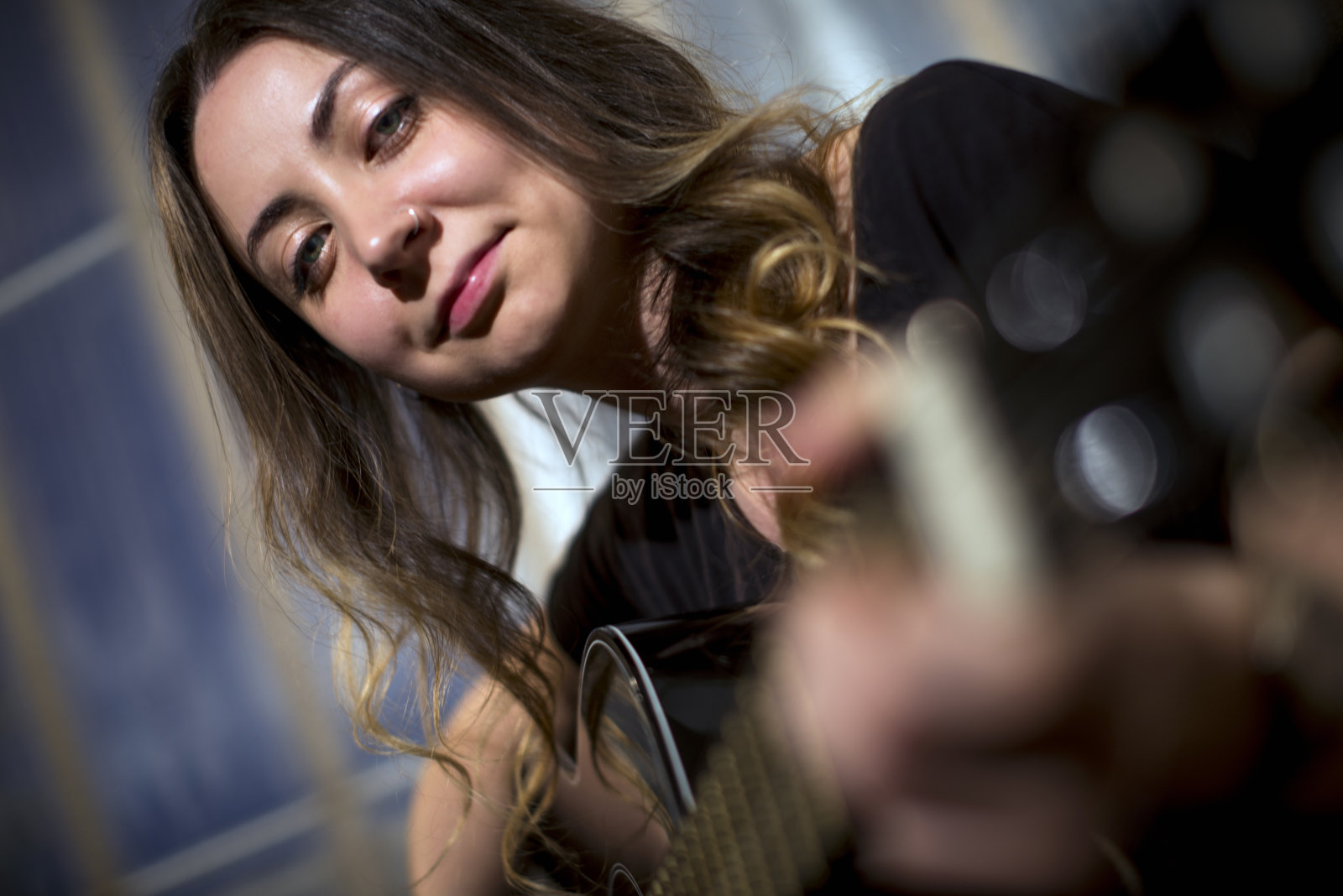 吉他玩的女孩。照片摄影图片