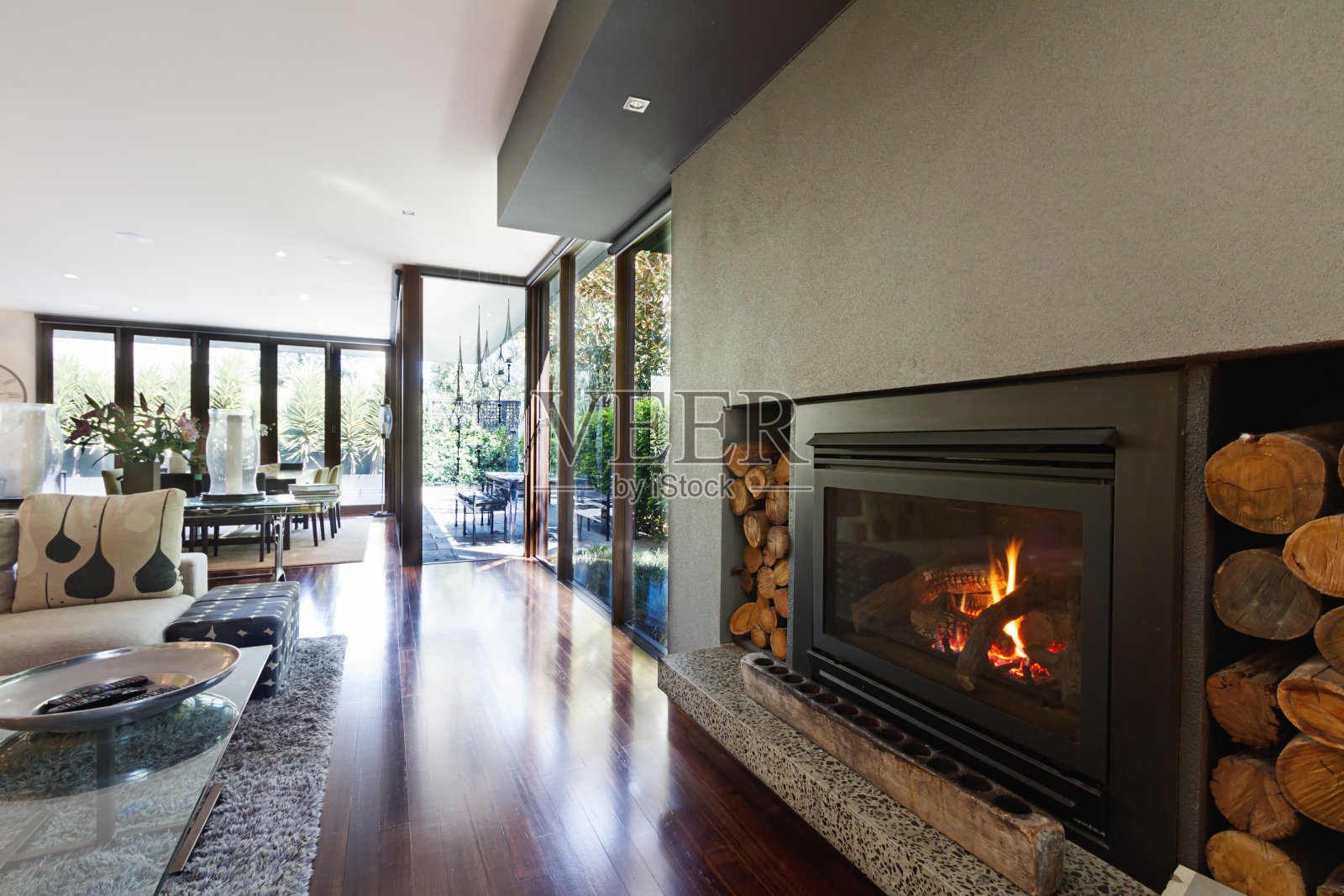 舒适的燃气原木火在建筑师设计的现代豪华开放式住宅照片摄影图片