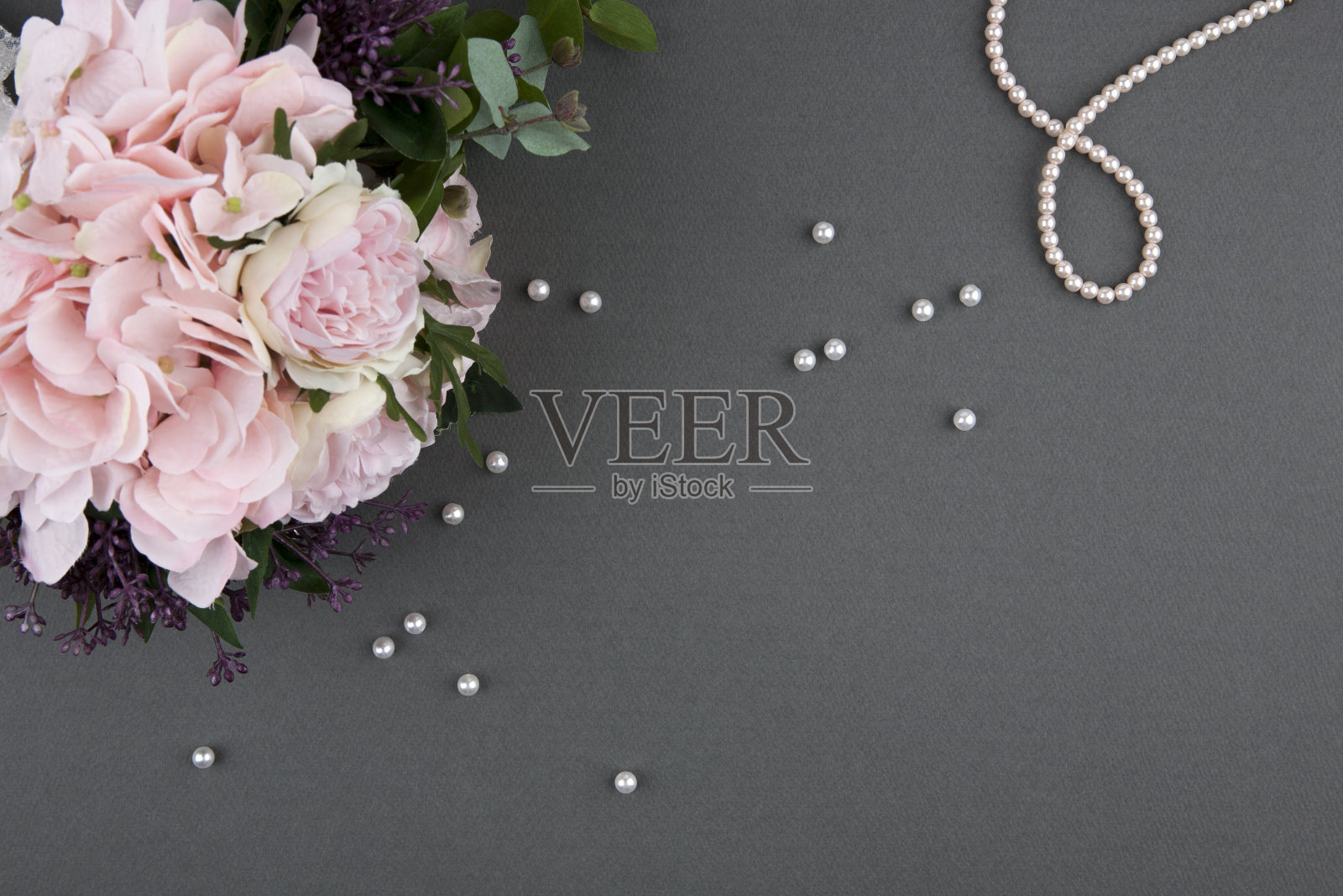 灰色背景的玫瑰花束和珍珠项链照片摄影图片