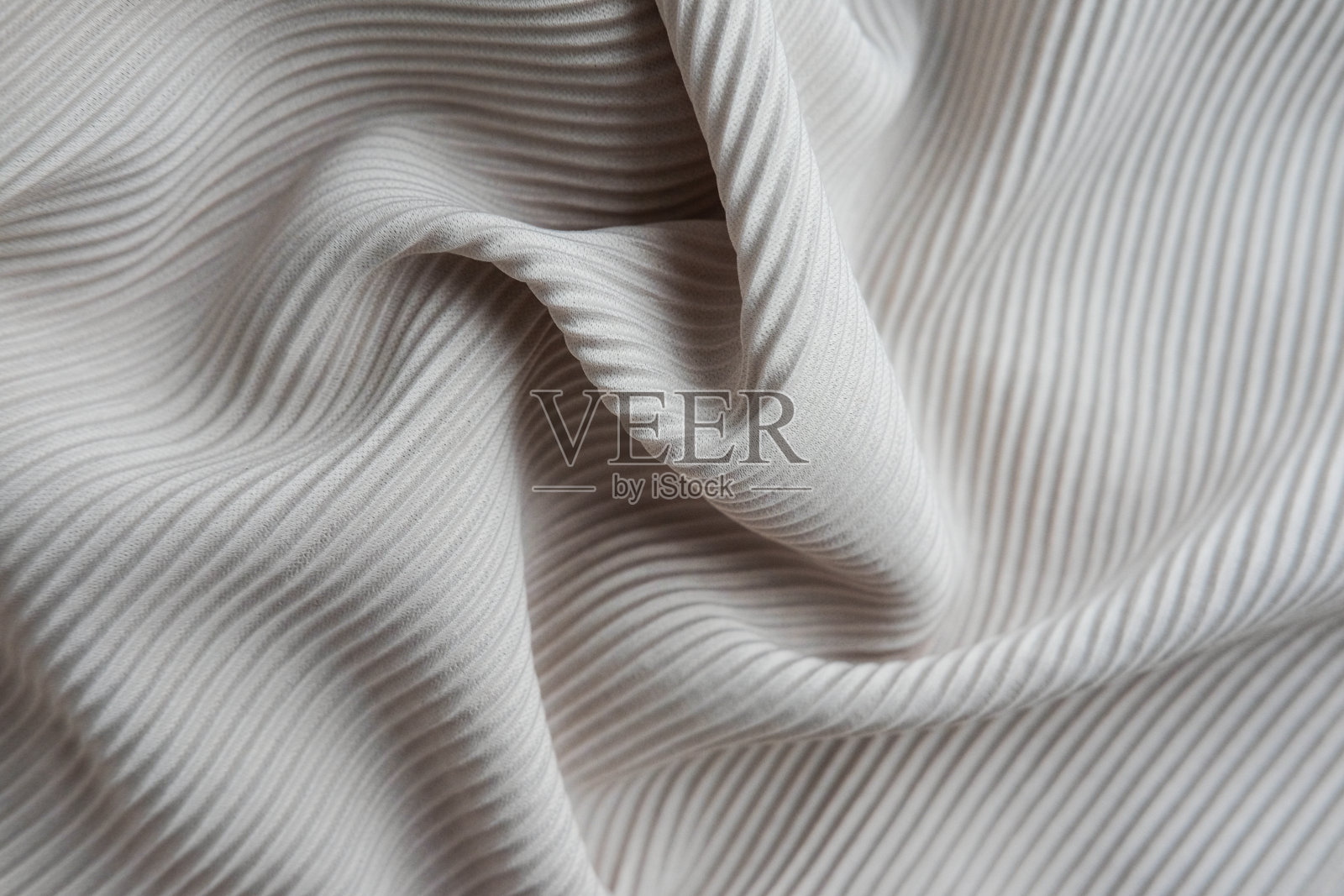 这种织物呈波浪状排列。灰色帆布材料纺织品。照片摄影图片