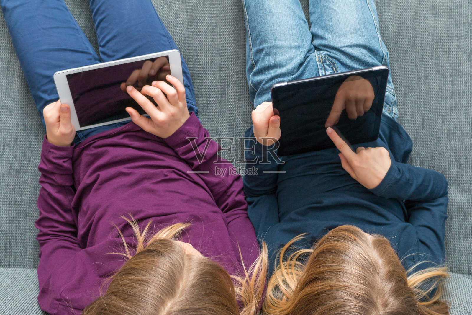俯视图2个女孩轻拍平板电脑照片摄影图片