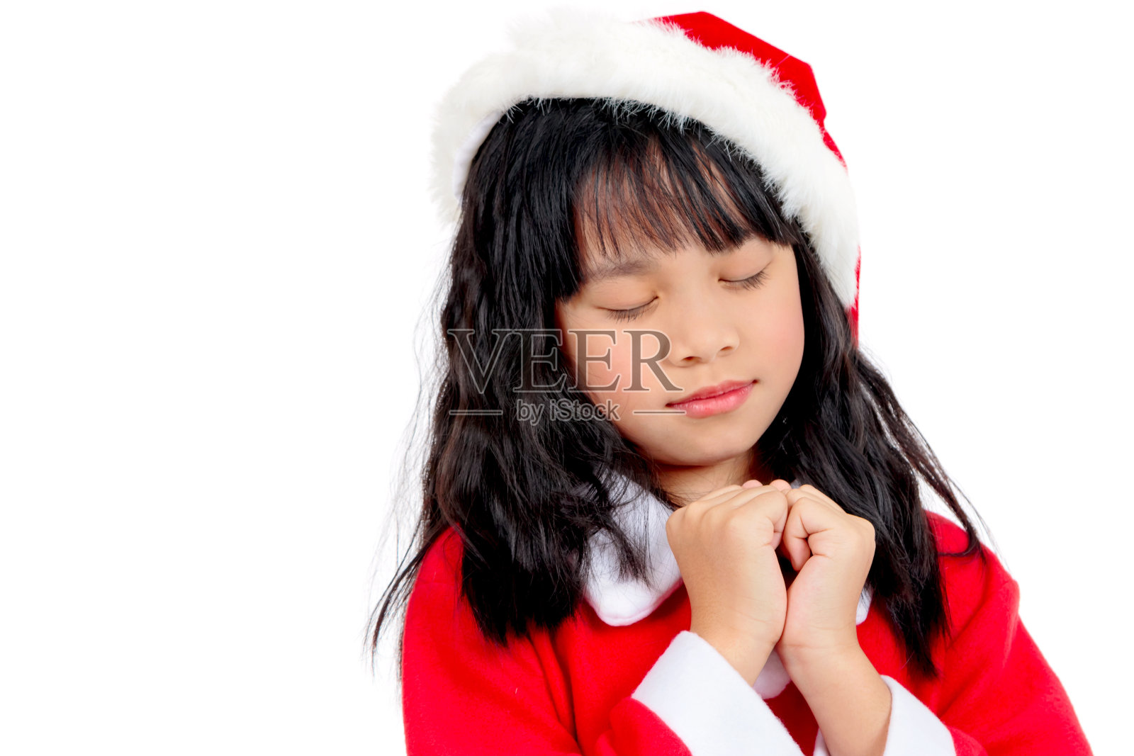 穿着圣诞老人服装的小女孩的肖像，圣诞节的概念照片摄影图片