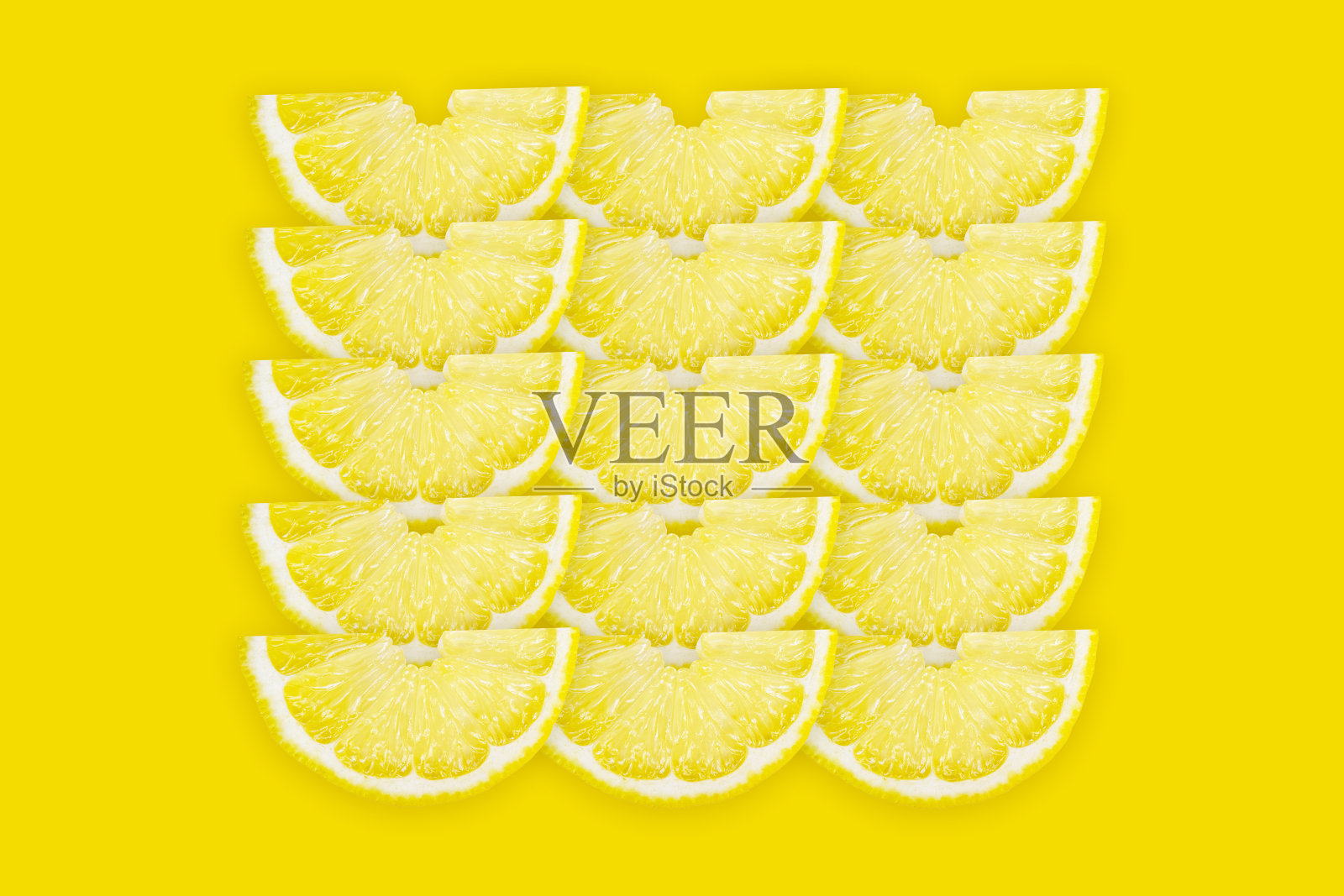 鲜柠檬半片图案在黄色背景上，俯视图。夏季明亮背景，柑橘类水果片，维生素c概念。照片摄影图片