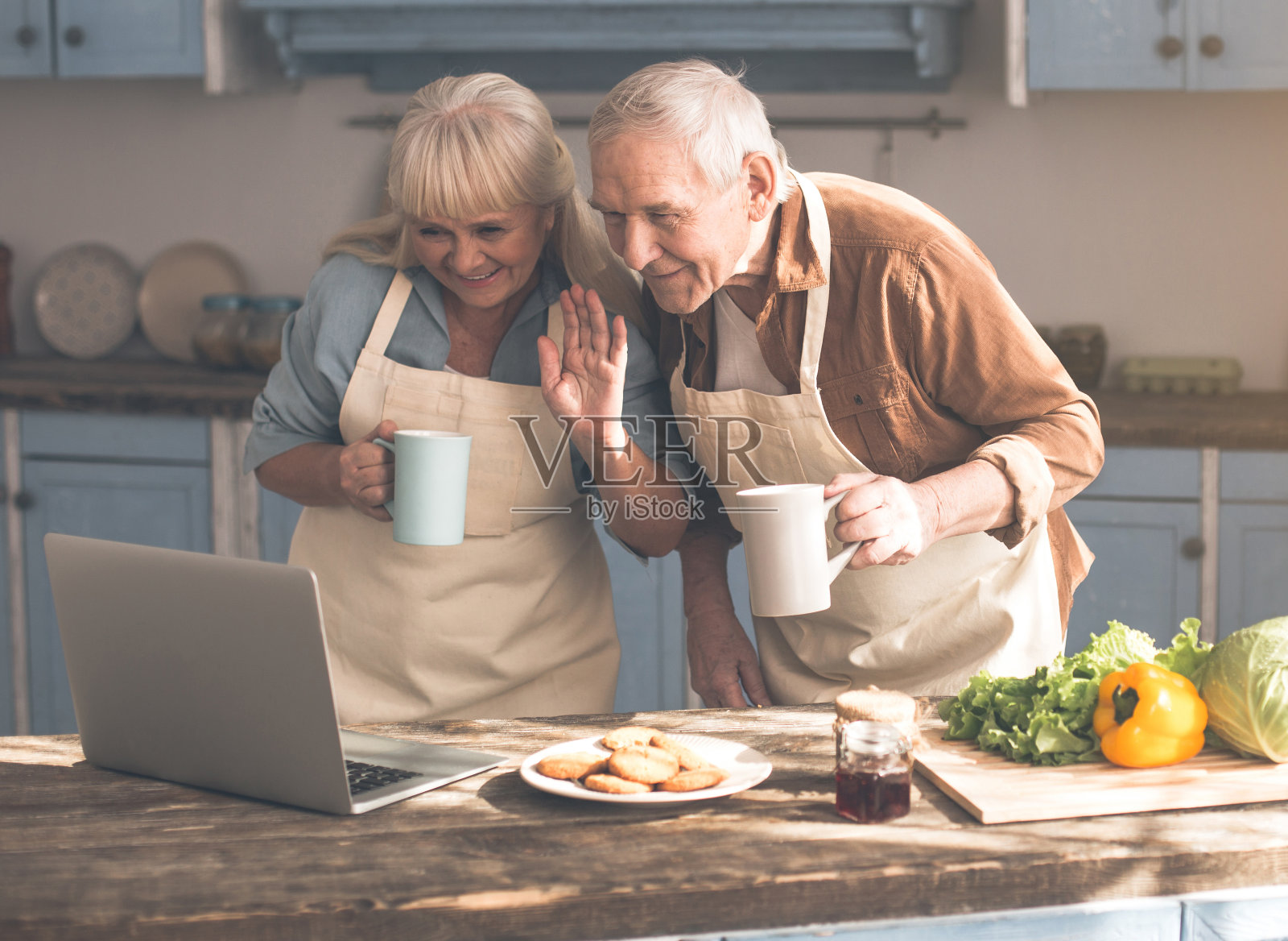 快乐的退休老人在厨房享受在线交流照片摄影图片