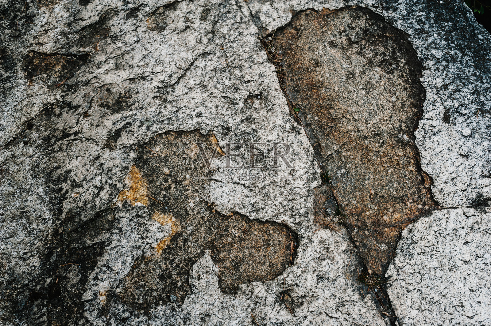 石头纹理背景。花岗岩和玄武岩的表面。一块大石头，一堵石墙。关闭了。文本。照片摄影图片