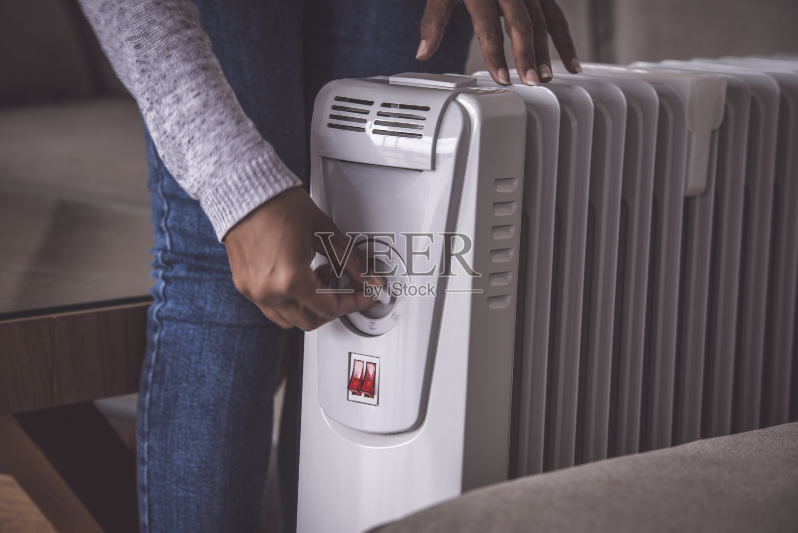 在寒冷的冬季增加/减少电加热器散热器的功率。照片摄影图片