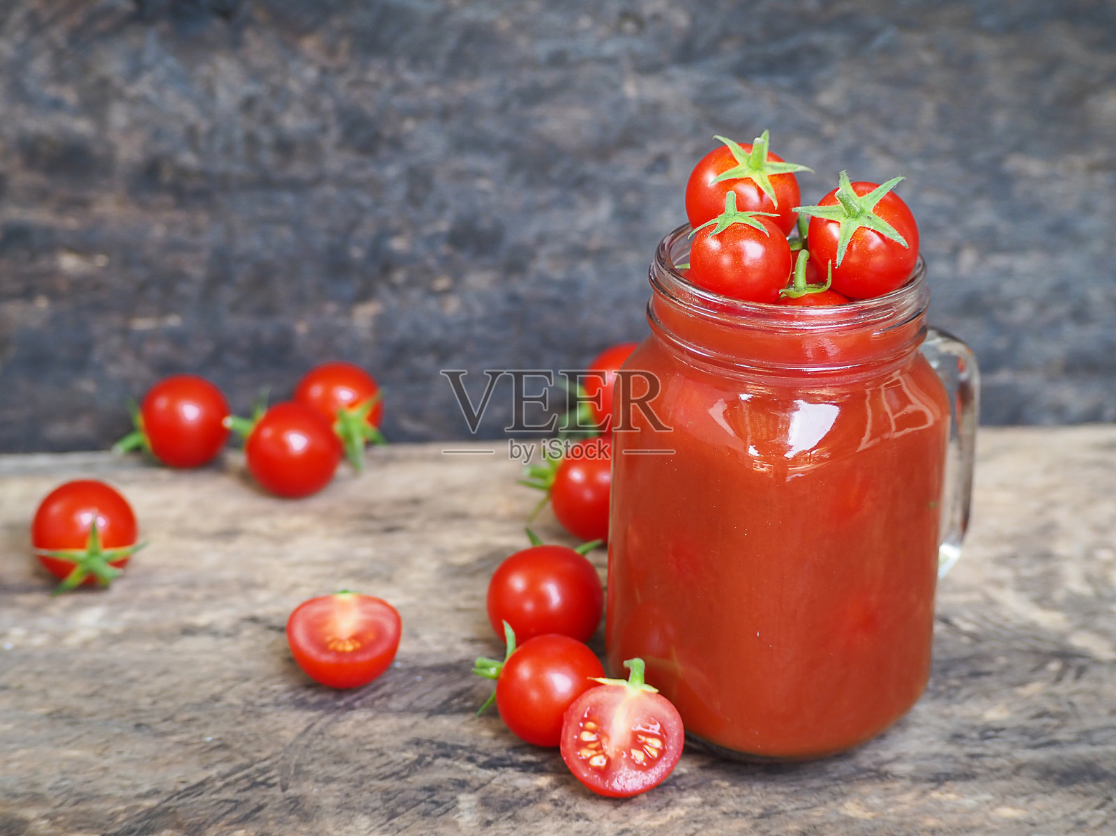 蕃茄汁与新鲜番茄在一个玻璃罐中，在木桌的背景，选择性的焦点照片摄影图片