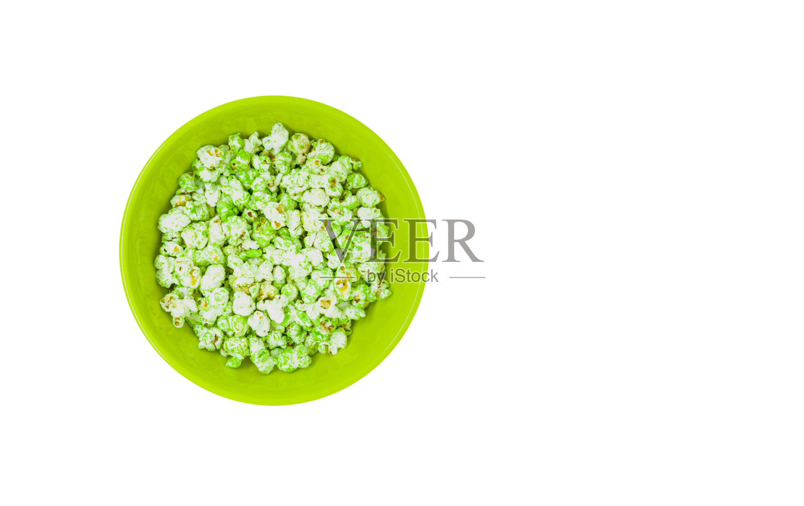 一碗孤立在白色背景上的爆米花。美味的爆米花在绿色碗与文字空间照片摄影图片
