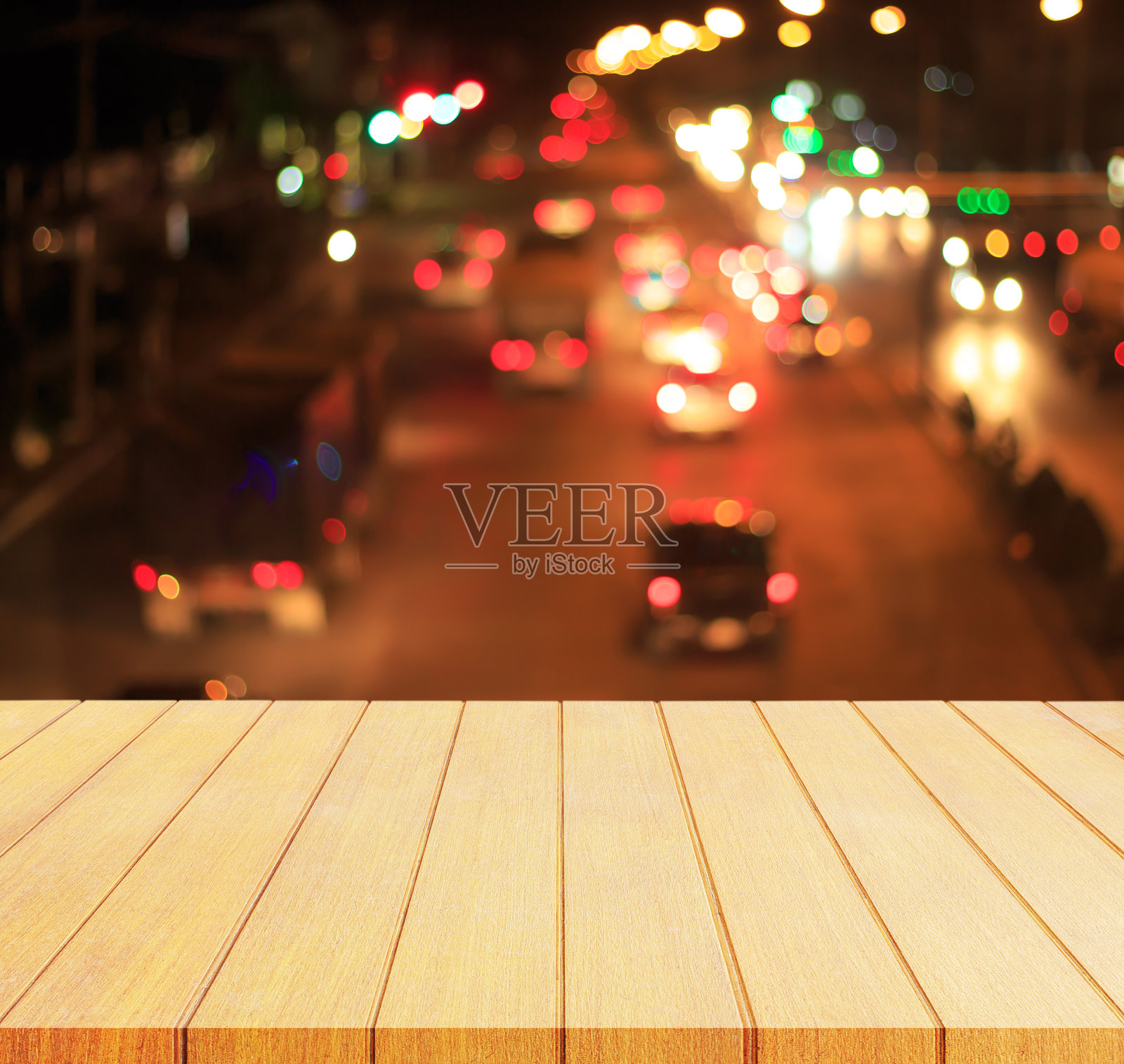 木质桌面在模糊的背景上的汽车在道路上的灯光在晚上照片摄影图片
