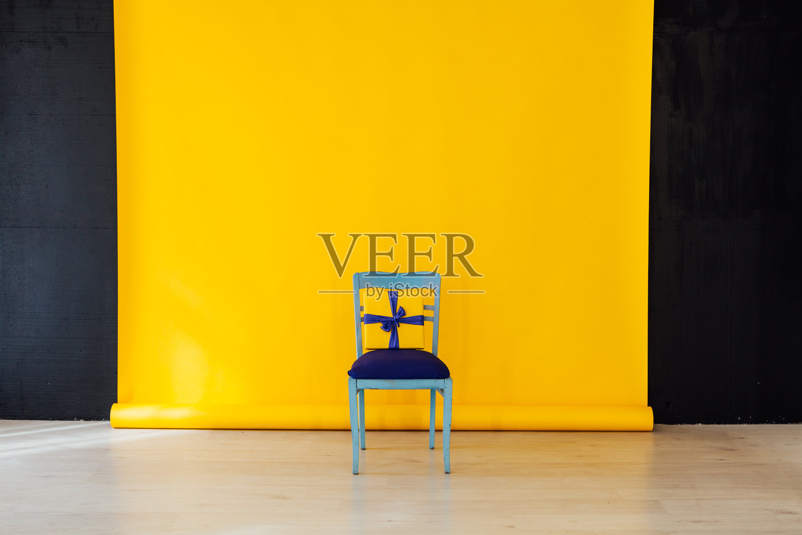房间内饰有黄色背景的蓝色椅子照片摄影图片