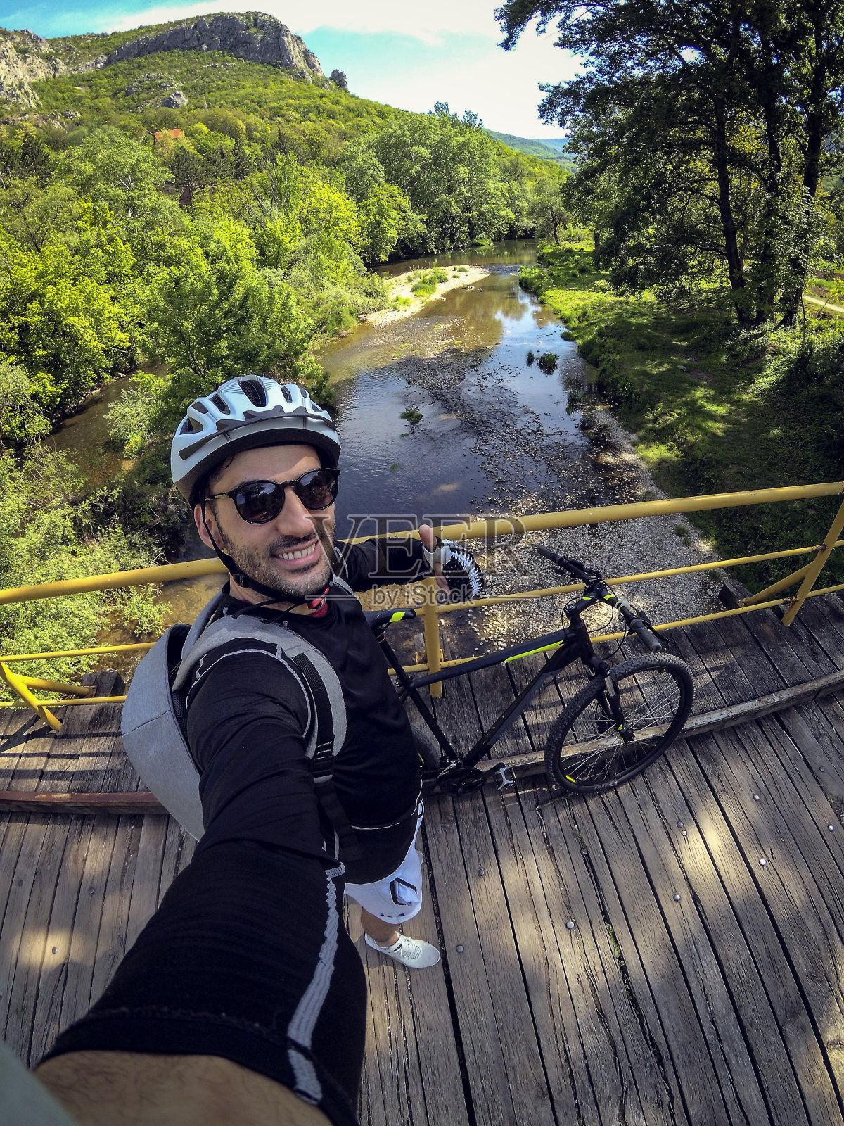 塞尔维亚一名男性山地自行车手正在穿越一座吊桥照片摄影图片