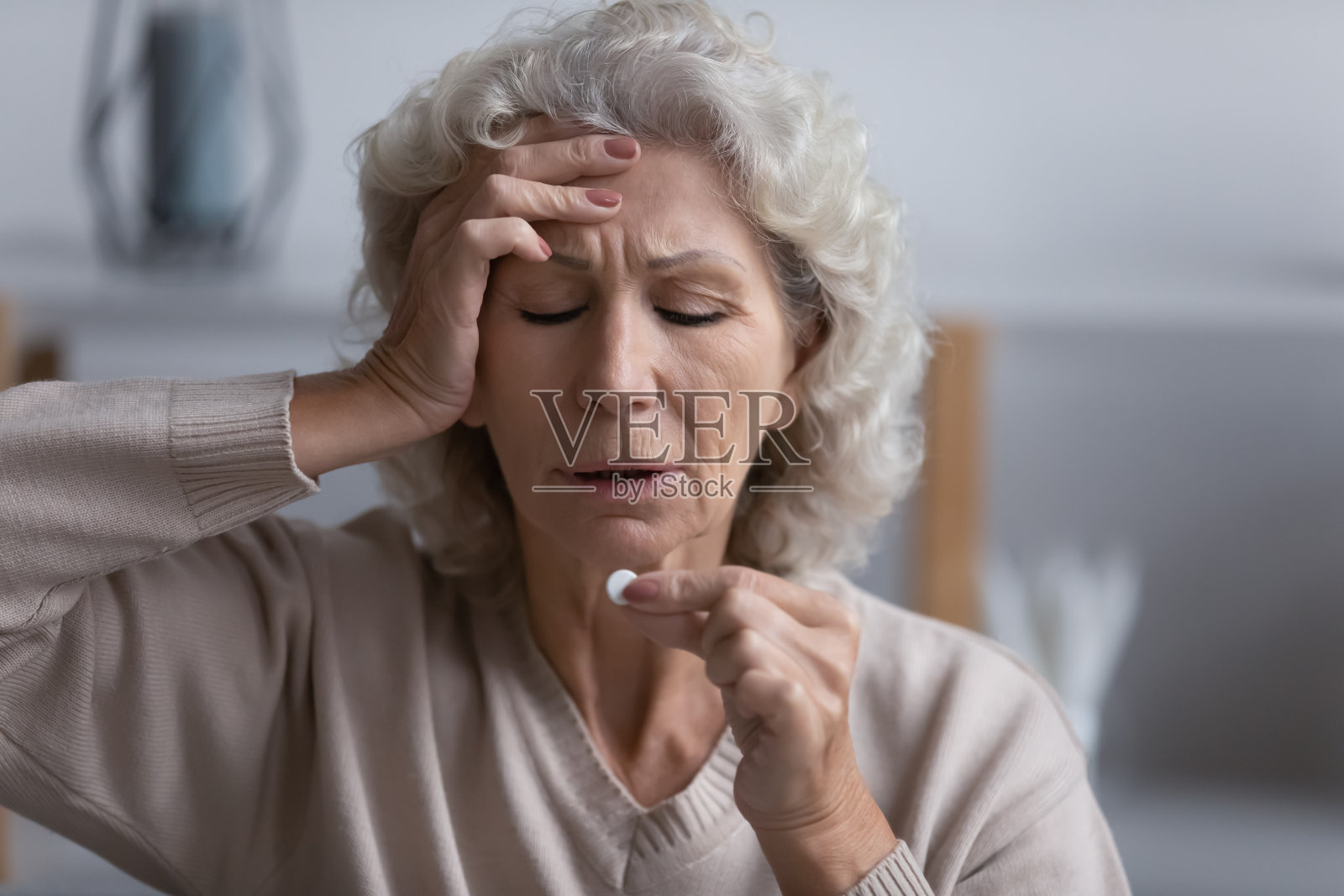 身体不健康的老年女性在家吃药照片摄影图片