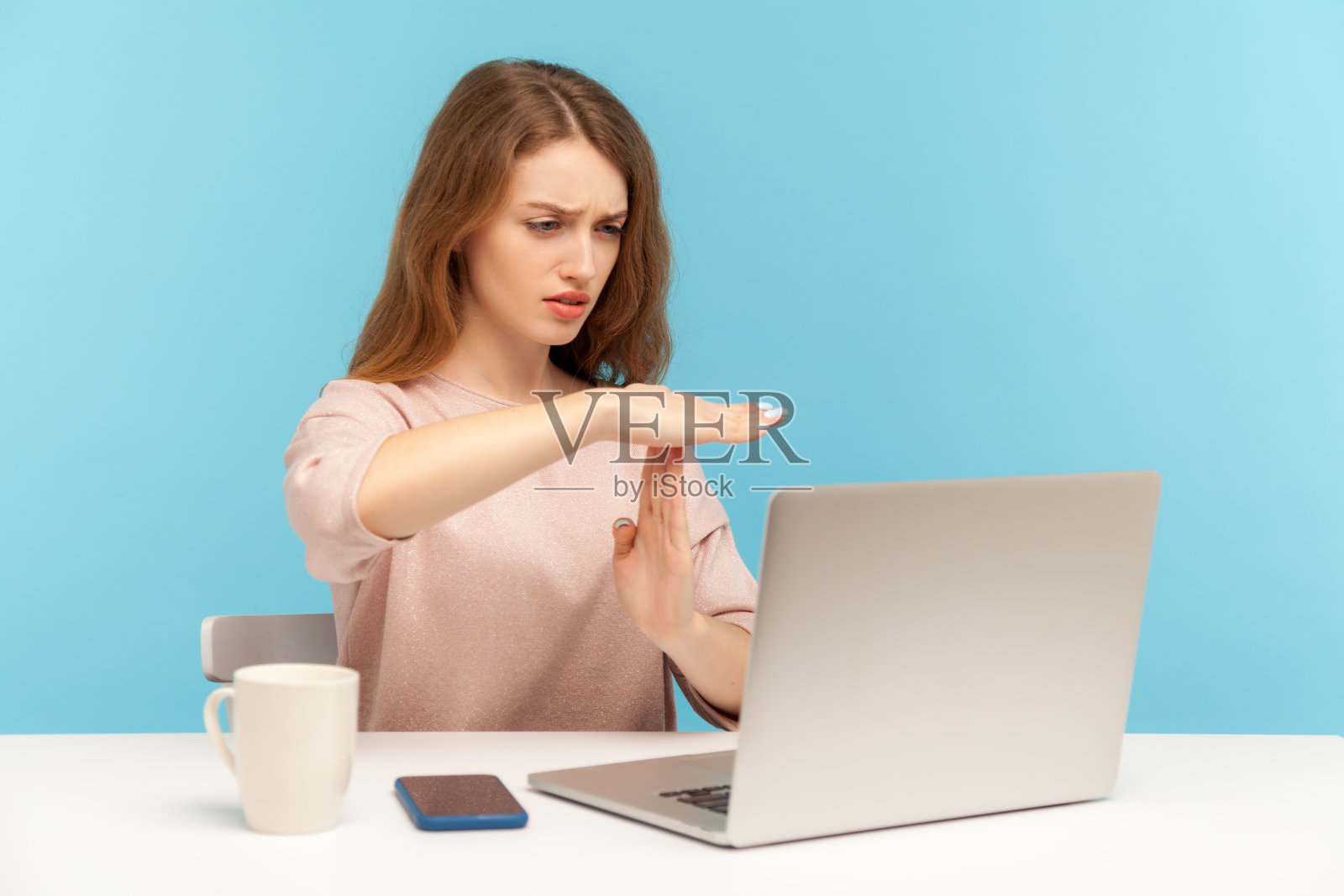 疲惫不安的女员工显示出休息的姿势，看着笔记本电脑屏幕，进行视频通话照片摄影图片