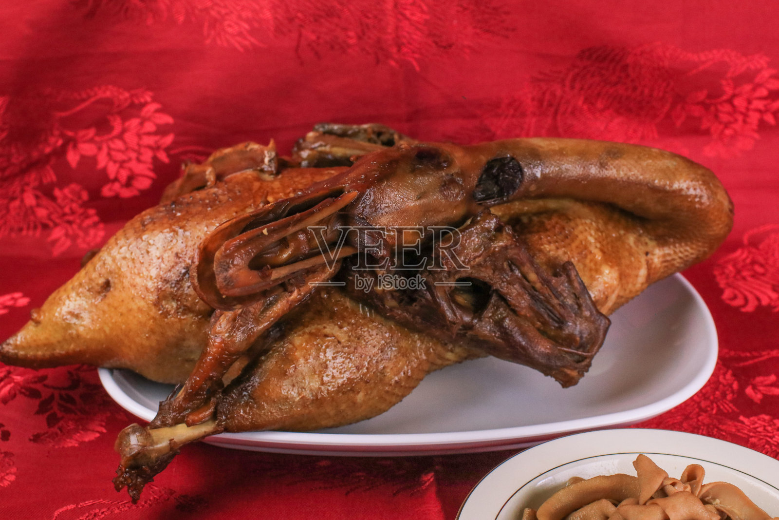 美味的金棕色鸭或清蒸鸭在Paloe或Lou mei酱(泰国名字是Pedpalow)，供中国新年祭祀的红色背景。照片摄影图片