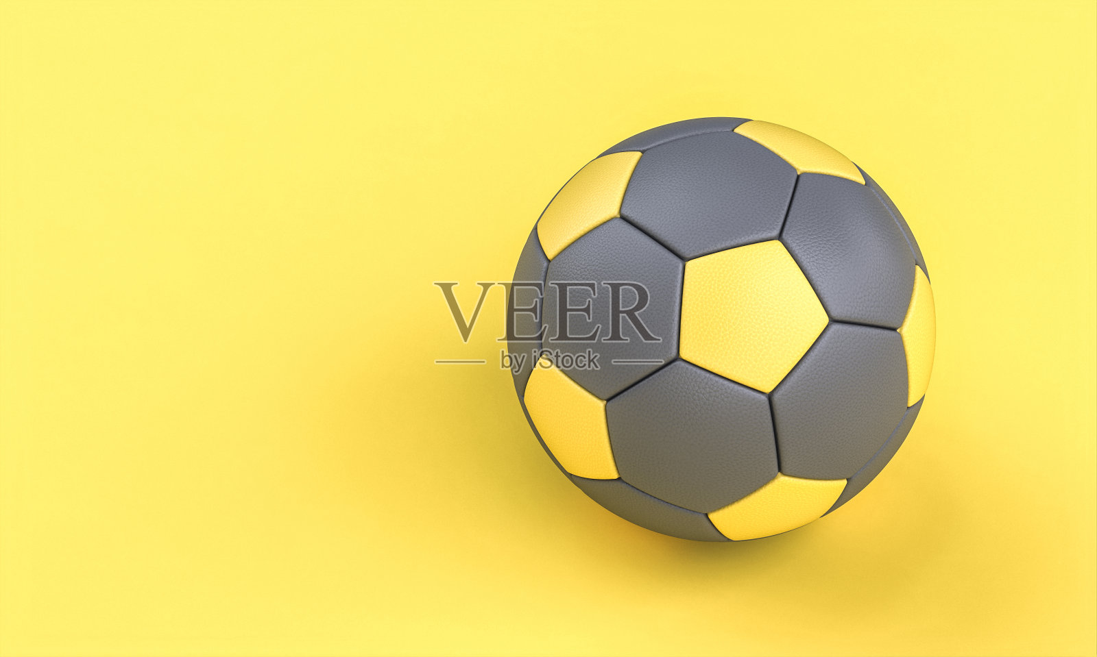灰色和黄色的足球在黄色的背景在平lay风格。照片摄影图片