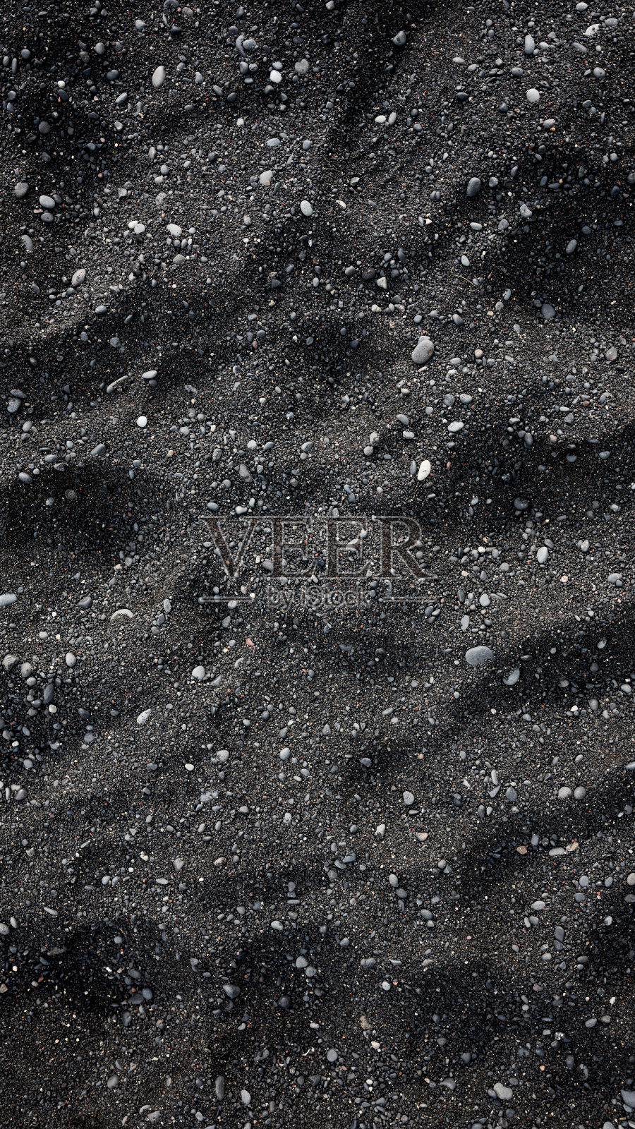黑色的沙子作为背景在冰岛海岸。抽象的成分。为设计和壁纸在电话上的形象。照片摄影图片